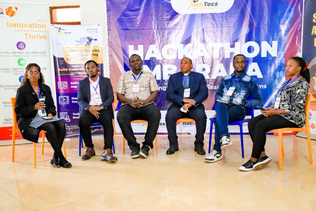 Panel discussion in front of the Hackathon Mbarara banner