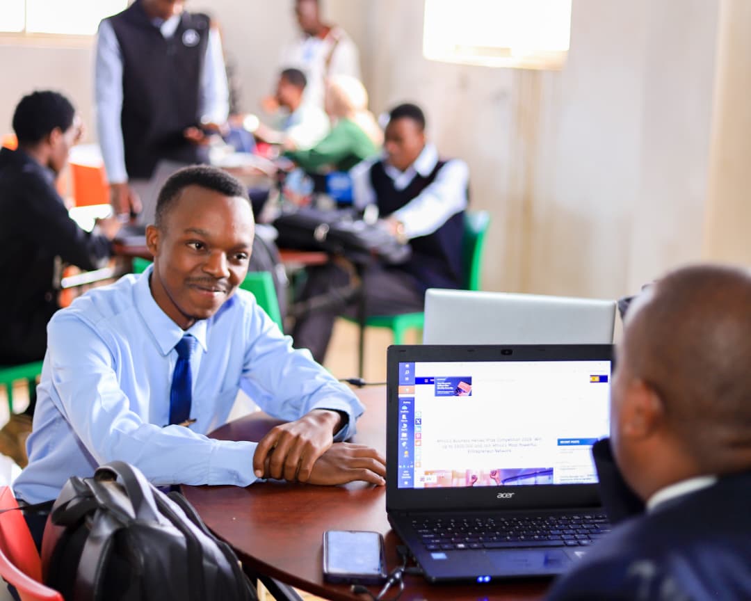 A participant at their laptop during Hackathon Mbarara 2026