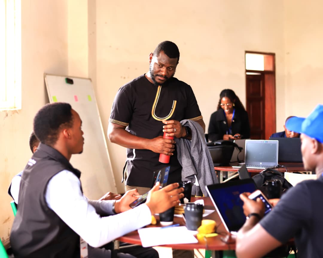 A mentor standing and talking through an idea with a seated participant